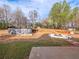 Backyard featuring an above ground pool, firepit, and a deck area at 7750 Silversmith Dr, Cumming, GA 30028