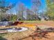 Expansive backyard with above ground pool, hot tub, firepit, and seating area at 7750 Silversmith Dr, Cumming, GA 30028