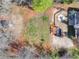 Aerial shot of a private backyard featuring an above-ground pool, fire pit, and green space at 7750 Silversmith Dr, Cumming, GA 30028