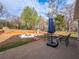 Relax on the patio by the fire pit in this landscaped backyard with space to relax and enjoy the outdoors at 7750 Silversmith Dr, Cumming, GA 30028