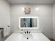 Bathroom featuring granite countertops, under mount sink, and a framed mirror at 7750 Silversmith Dr, Cumming, GA 30028