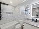 Sleek bathroom featuring modern fixtures, marble tile, a large shower, and a vanity at 7750 Silversmith Dr, Cumming, GA 30028
