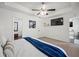 Bright primary bedroom featuring plush carpeting, white trim, and a ceiling fan at 7750 Silversmith Dr, Cumming, GA 30028