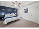 The primary bedroom features plush carpet, white trim, and a dark accent wall at 7750 Silversmith Dr, Cumming, GA 30028