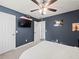 Bedroom with a ceiling fan, TV and view of the ensuite bathroom at 7750 Silversmith Dr, Cumming, GA 30028