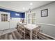 Dining area features a dining table, windows for natural light, and adjacent kitchen with storage at 7750 Silversmith Dr, Cumming, GA 30028