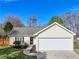 Charming single-story home with manicured lawn, attached garage and welcoming curb appeal at 7750 Silversmith Dr, Cumming, GA 30028