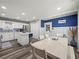 Bright kitchen features white cabinets and island, stainless appliances, and adjacent dining area with natural light at 7750 Silversmith Dr, Cumming, GA 30028