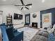 Cozy living room featuring vaulted ceiling, fireplace, stylish furniture, and hardwood floors at 7750 Silversmith Dr, Cumming, GA 30028