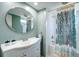 Charming bathroom featuring a modern vanity, round mirror, and patterned shower curtain at 20 Screven Ne St, Atlanta, GA 30307