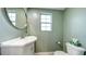 Charming bathroom with a sleek sink vanity, round mirror, and classic fixtures at 20 Screven Ne St, Atlanta, GA 30307
