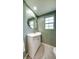 Charming bathroom with a sleek sink vanity, round mirror, and classic fixtures at 20 Screven Ne St, Atlanta, GA 30307