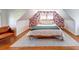Bright bedroom featuring floral wallpaper, wood floors, and a comfortable seating area at 20 Screven Ne St, Atlanta, GA 30307