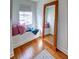 Charming bedroom nook with a built-in window seat, decorative pillows, a cozy throw, and a large, decorative standing mirror at 20 Screven Ne St, Atlanta, GA 30307