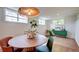 Bright dining room featuring modern decor, large windows, and a unique light fixture above a wood table at 20 Screven Ne St, Atlanta, GA 30307