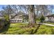 Beautiful home with a lush green lawn, gated entrance and long driveway framed by mature trees at 20 Screven Ne St, Atlanta, GA 30307