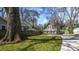 Beautiful home with a lush green lawn, gated entrance and long driveway framed by mature trees at 20 Screven Ne St, Atlanta, GA 30307