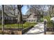 Beautiful home with a lush green lawn, gated entrance and long driveway framed by mature trees at 20 Screven Ne St, Atlanta, GA 30307