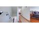 Hallway with wood floors leading to bedroom with wood floors and natural light at 20 Screven Ne St, Atlanta, GA 30307