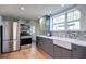 Modern kitchen featuring stainless steel appliances, mosaic tile backsplash, and ample natural light at 20 Screven Ne St, Atlanta, GA 30307