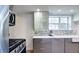 Modern kitchen featuring stainless steel appliances, mosaic tile backsplash, and marble countertops at 20 Screven Ne St, Atlanta, GA 30307