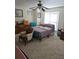 Cozy bedroom featuring a ceiling fan, a sitting chair, and a window with natural light at 315 Saratoga Pl, Riverdale, GA 30296
