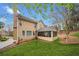 Well-maintained backyard featuring a screened-in porch, lush lawn, mature trees, and charming exterior at 1421 Briarcliff Dr, Woodstock, GA 30189