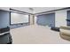 Basement featuring plush carpeting, neutral walls, and a comfortable seating area with a projector screen at 1421 Briarcliff Dr, Woodstock, GA 30189