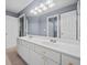 Bathroom with double sink vanity, ample lighting, and modern fixtures offers a clean, bright space at 1421 Briarcliff Dr, Woodstock, GA 30189