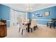 Elegant dining room featuring blue walls, bay window, and a modern chandelier at 1421 Briarcliff Dr, Woodstock, GA 30189