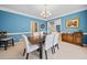Charming dining room features blue walls, crown molding, and elegant furniture at 1421 Briarcliff Dr, Woodstock, GA 30189
