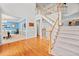Open entryway with hardwood floors, staircase with carpet runner, and adjacent dining room at 1421 Briarcliff Dr, Woodstock, GA 30189