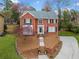Charming two-story brick home with black shutters and a well-manicured lawn at 1421 Briarcliff Dr, Woodstock, GA 30189