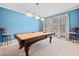 Bright game room features a billiard table, pendant lighting, and neutral carpet at 1421 Briarcliff Dr, Woodstock, GA 30189