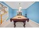 Game room with billiard table, pendant lighting, and stairs to upper level at 1421 Briarcliff Dr, Woodstock, GA 30189