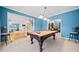 Spacious game room with a billiard table, hardwood flooring, and stairs to main level at 1421 Briarcliff Dr, Woodstock, GA 30189