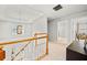 Upstairs hallway with pendant lighting, wood railing, and neutral carpet at 1421 Briarcliff Dr, Woodstock, GA 30189