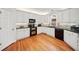 Well-lit kitchen features white cabinets, granite countertops, and stainless steel appliances at 1421 Briarcliff Dr, Woodstock, GA 30189