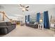 Bright, open living room with hardwood floors, fireplace, and adjacent kitchen and dining areas at 1421 Briarcliff Dr, Woodstock, GA 30189