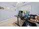 Bright home office with a sit stand desk, computer setup, and a relaxing blue chair at 1421 Briarcliff Dr, Woodstock, GA 30189