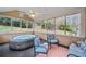Charming sun room with a hot tub, tiled flooring, and large windows overlooking the landscaped backyard at 1421 Briarcliff Dr, Woodstock, GA 30189