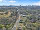 Aerial view showcasing the property's location in relation to the city skyline, surrounding trees, and neighborhood at 1450 Donald Lee Hollowell Nw Pkwy, Atlanta, GA 30318
