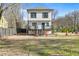 View of backyard featuring a two-story house with a fenced yard, and small plants and trees at 1450 Donald Lee Hollowell Nw Pkwy, Atlanta, GA 30318