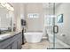 Modern bathroom features a soaking tub, glass shower, and vanity with granite countertop at 1450 Donald Lee Hollowell Nw Pkwy, Atlanta, GA 30318
