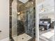 Bathroom featuring a marble shower with glass doors and a tile base, adjacent to the main bedroom at 1450 Donald Lee Hollowell Nw Pkwy, Atlanta, GA 30318
