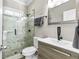 Bathroom with marble shower, grey vanity, and hardwood floors at 1450 Donald Lee Hollowell Nw Pkwy, Atlanta, GA 30318