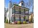 Charming two-story home with a double porch, offering curb appeal and outdoor living space at 1450 Donald Lee Hollowell Nw Pkwy, Atlanta, GA 30318
