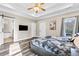 Spacious main bedroom with trey ceilings, wood floors, and access to ensuite bathroom and covered deck at 1450 Donald Lee Hollowell Nw Pkwy, Atlanta, GA 30318