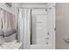 White tiled shower and bath, with brushed nickel trim, shower curtain and granite vanity at 200 Oakside Way, Lawrenceville, GA 30046