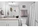 Bright bathroom with a vanity, toilet, shower with curtain, and modern decorations at 200 Oakside Way, Lawrenceville, GA 30046